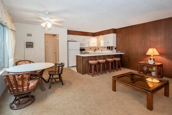 a room with furniture a table and a chandelier