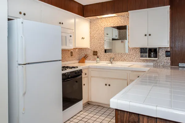 a kitchen with a sink appliances and cabinets