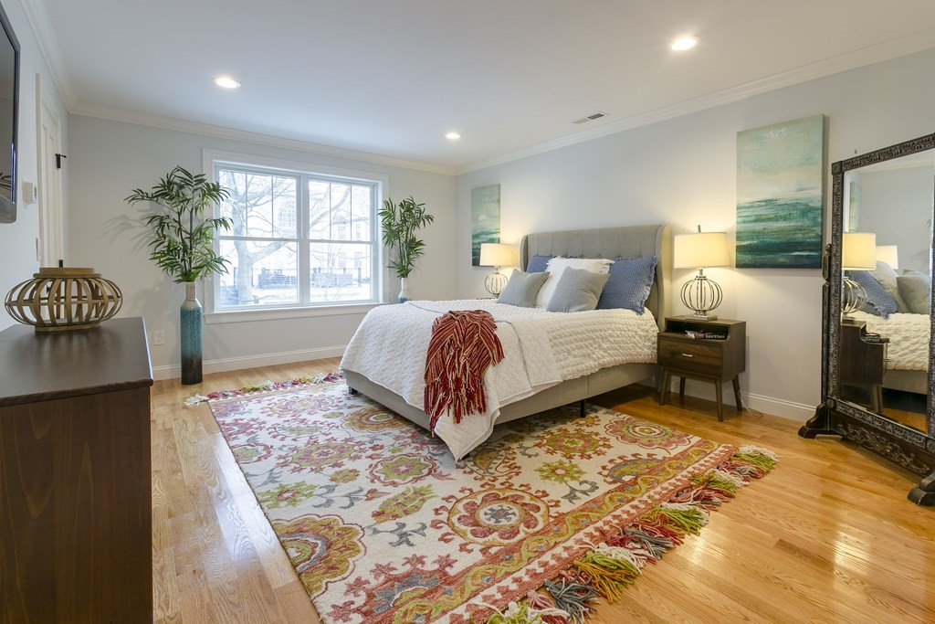 211 West Street, Unit 211 Needham, MA 02494 - Photo 18 of 29 a bedroom with a bed and a window