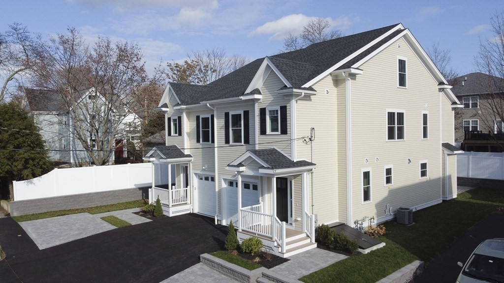 211 West Street, Unit 211 Needham, MA 02494 - Photo 2 of 29 a front view of a house with garden