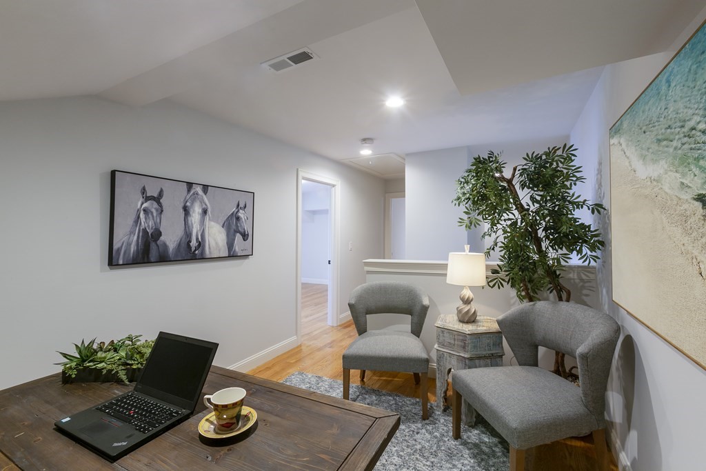 211 West Street, Unit 211 Needham, MA 02494 - Photo 26 of 29 a living room with furniture flowerpot and wooden floor