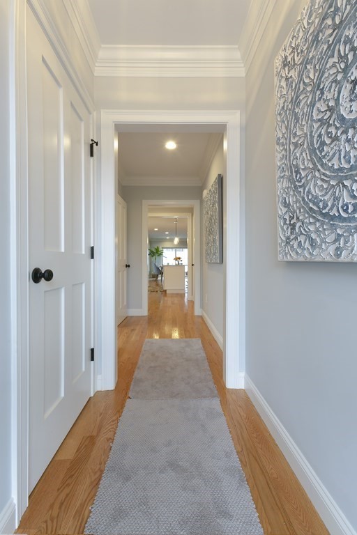 211 West Street, Unit 211 Needham, MA 02494 - Photo 3 of 29 a view of a hallway with wooden floor and a bathroom