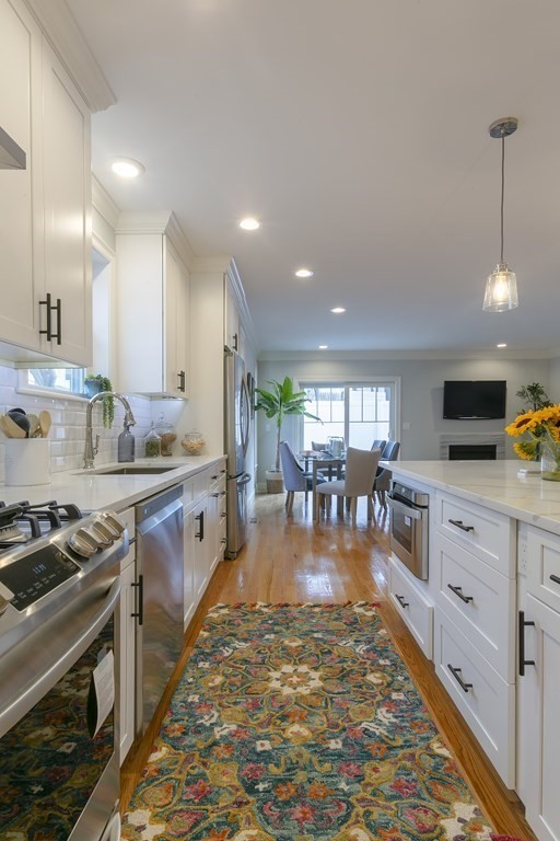 211 West Street, Unit 211 Needham, MA 02494 - Photo 6 of 29 a large kitchen with lots of counter top space and stainless steel appliances