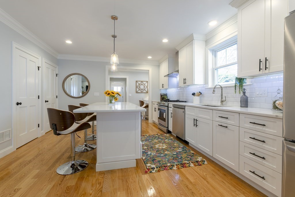 211 West Street, Unit 211 Needham, MA 02494 - Photo 8 of 29 a kitchen with cabinets and wooden floor