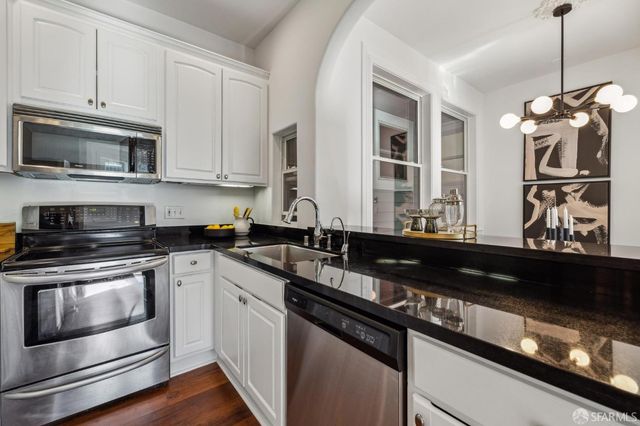 a kitchen with stainless steel appliances granite countertop a stove and a microwave