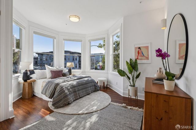 a living room with furniture a couch and a flat screen tv