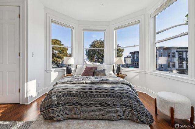 a bedroom with a bed and windows