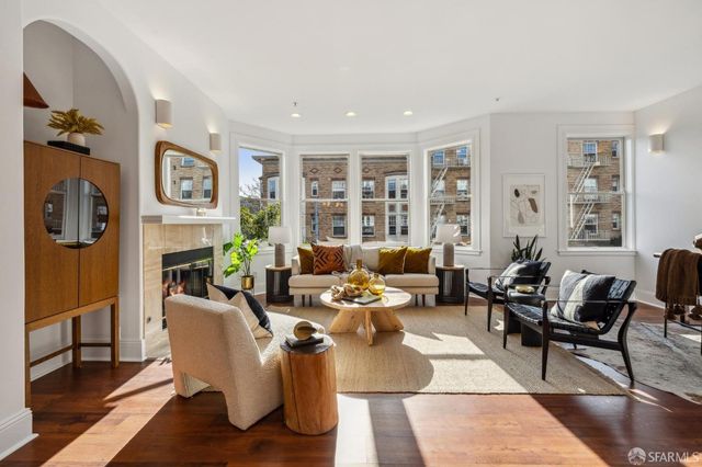 a living room with fireplace furniture and a window