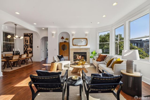 a living room with furniture a fireplace and a table