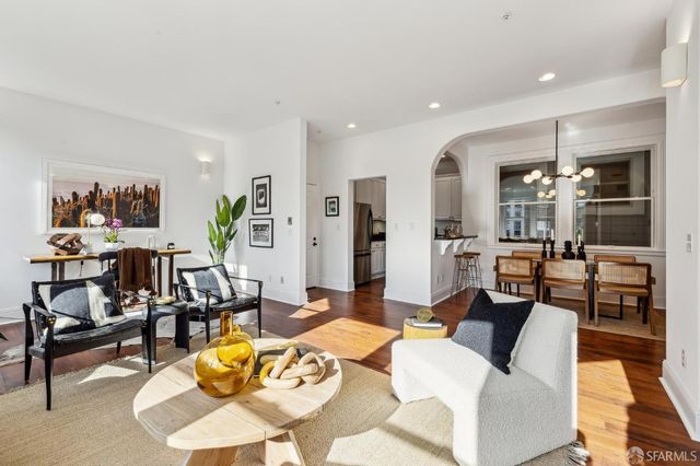 a living room with furniture kitchen view and a table
