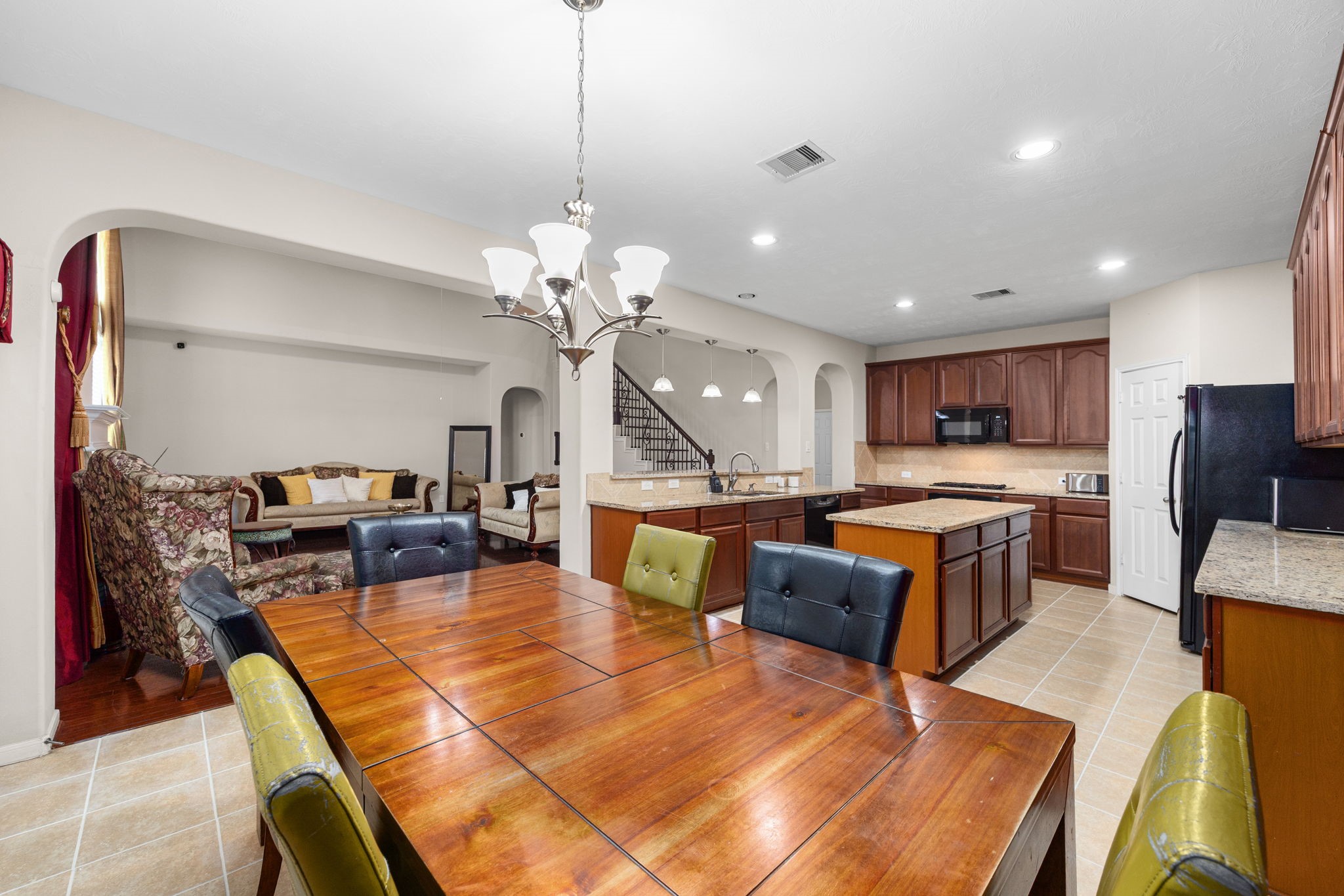 6719 Latchmore Lane Houston, TX 77049 - Photo 11 of 46 a living room with fireplace furniture and a kitchen view