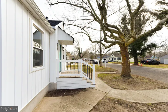 a view of a house with a yard and lawn chairs