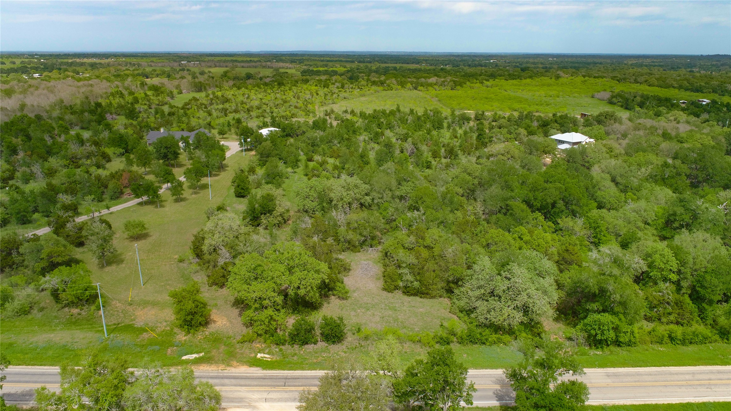 0 Fm 535 Road Red Rock, TX 78662 - Photo 3 of 6 An aerial panorama reveals verdant, rolling acreage with secluded residential properties.