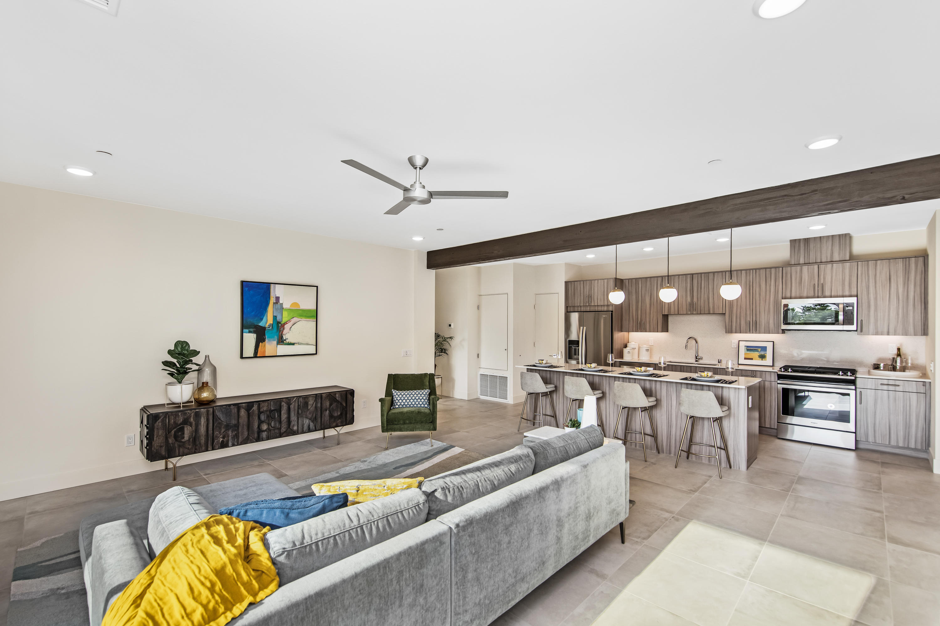a living room with stainless steel appliances kitchen island granite countertop furniture and a view of kitchen
