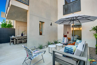 161 The Riv Palm Springs, CA 92262 - Photo 13 of 15 a view of a dining room with furniture and chandelier