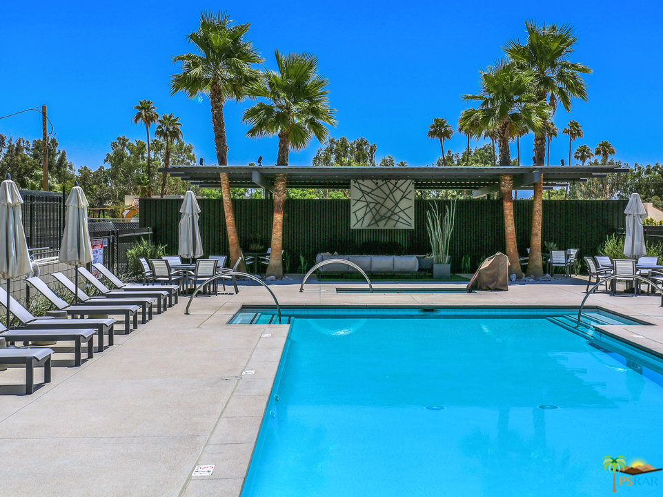 161 The Riv Palm Springs, CA 92262 - Photo 7 of 15 a view of a swimming pool with chairs