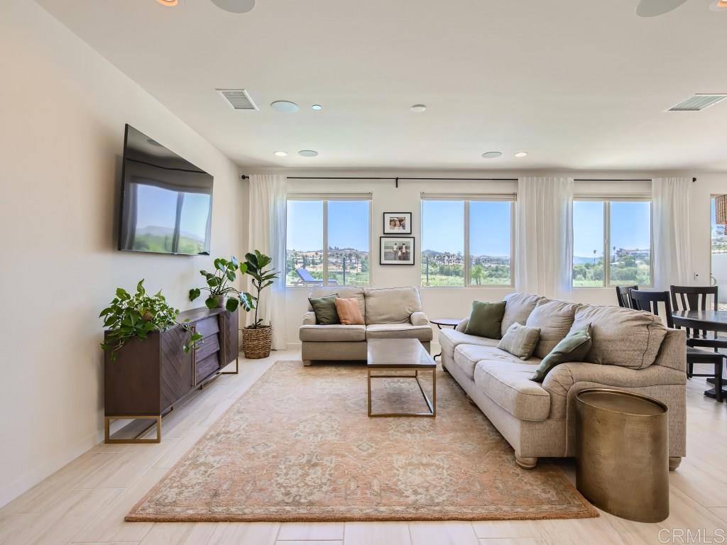 31657 Calle De Las Estrellas Bonsall, CA 92003 - Photo 11 of 24 a living room with furniture potted plant kitchen and a window