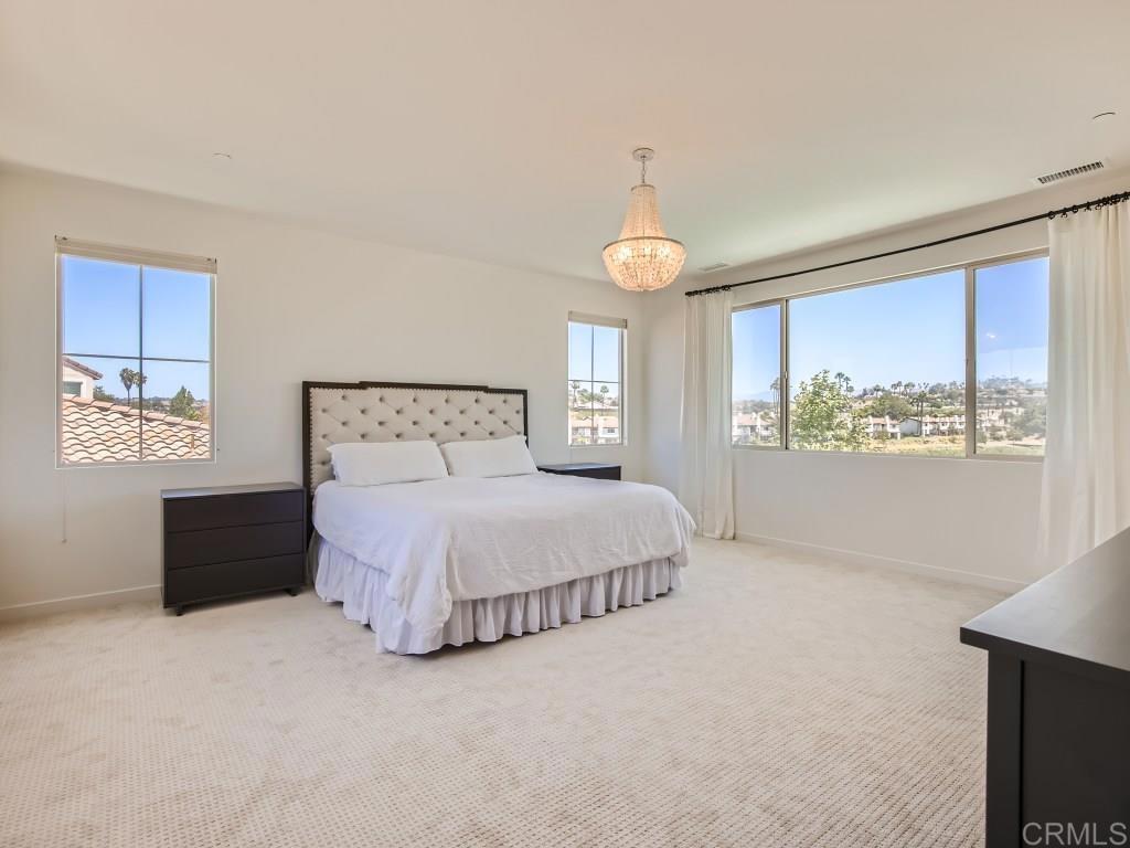 31657 Calle De Las Estrellas Bonsall, CA 92003 - Photo 14 of 24 a bedroom with a large bed and a window
