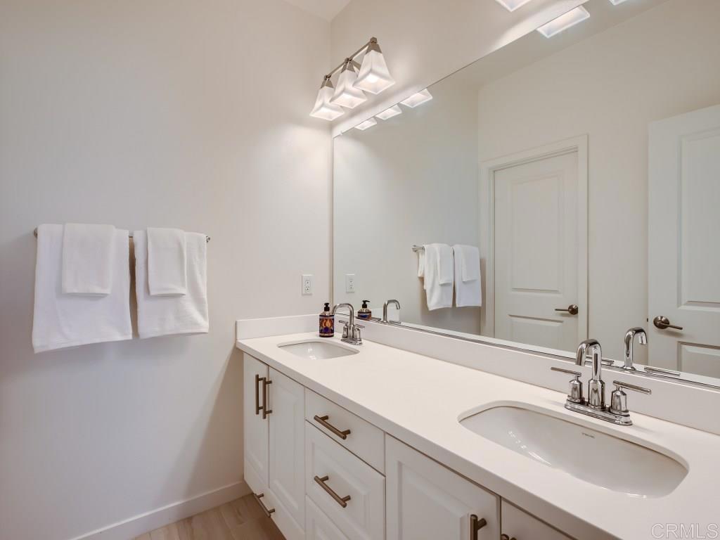 31657 Calle De Las Estrellas Bonsall, CA 92003 - Photo 19 of 24 a bathroom with a double vanity sink and a mirror
