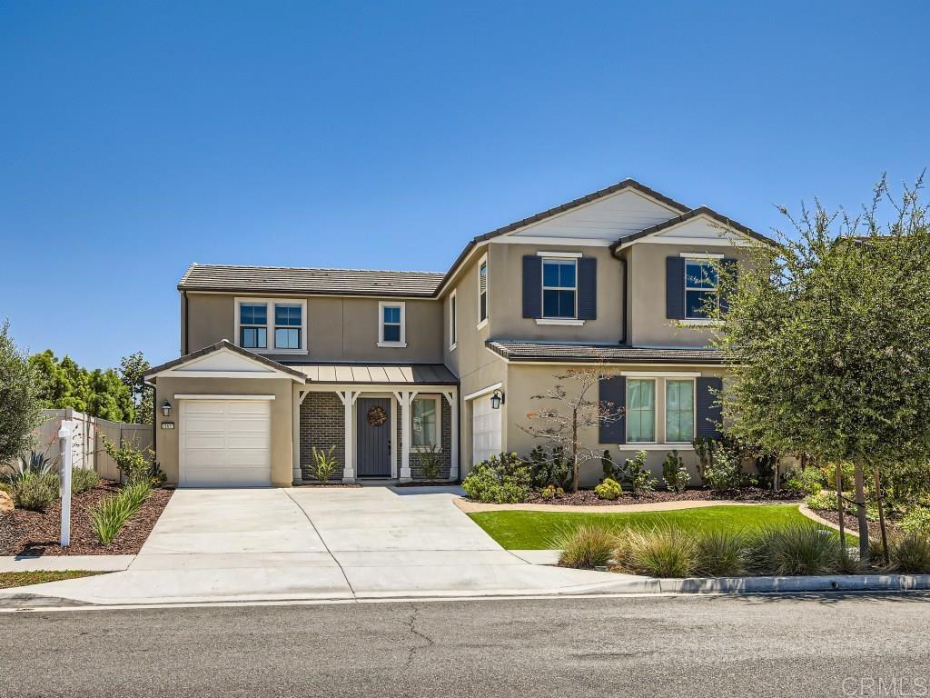 31657 Calle De Las Estrellas Bonsall, CA 92003 - Photo 23 of 24 a front view of a house with a yard and garage