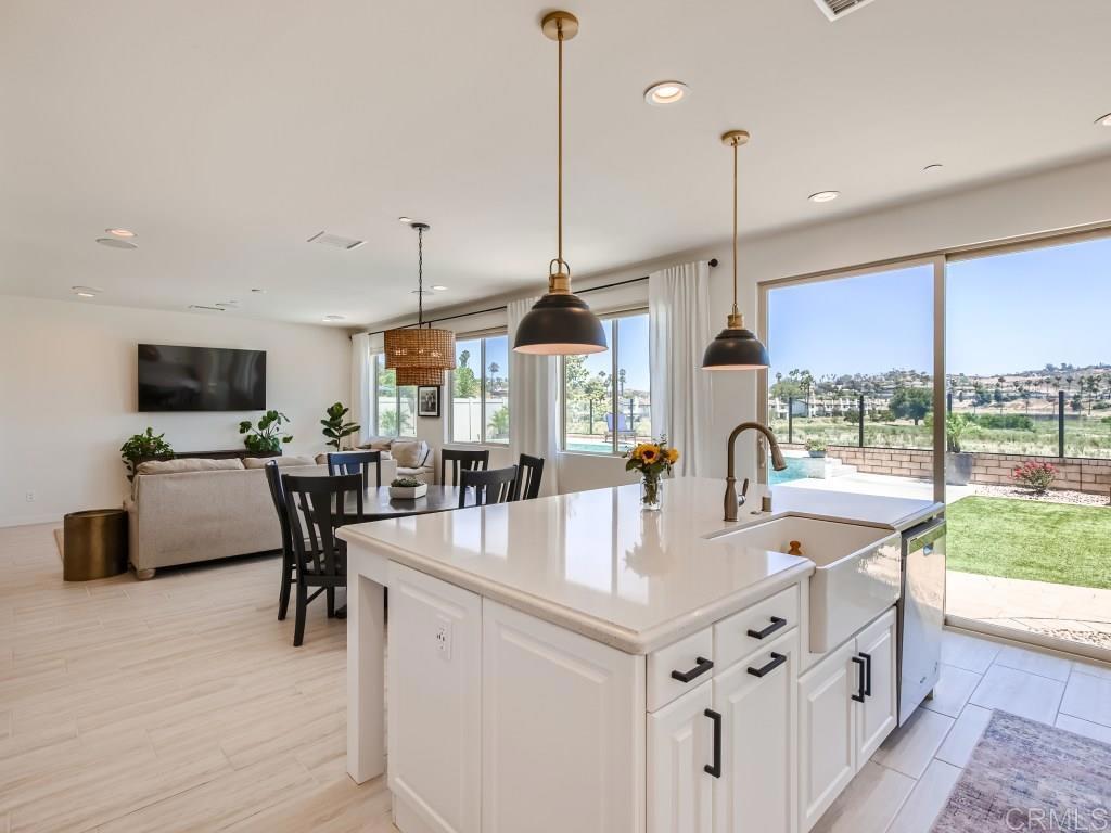 31657 Calle De Las Estrellas Bonsall, CA 92003 - Photo 3 of 24 a large kitchen with kitchen island a large counter space a sink appliances and a large window