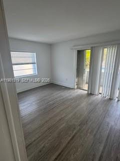 9225 Southwest 87th Avenue, Unit A6 Miami, FL 33176 - Photo 11 of 16 an empty room with wooden floor and windows