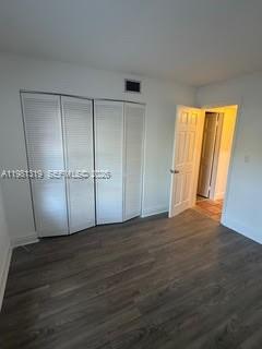 9225 Southwest 87th Avenue, Unit A6 Miami, FL 33176 - Photo 15 of 16 a view of an empty room with wooden floor and a window