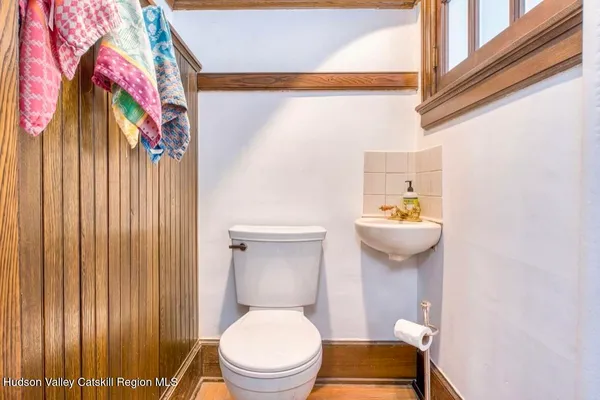 a bathroom with a toilet and shower curtain