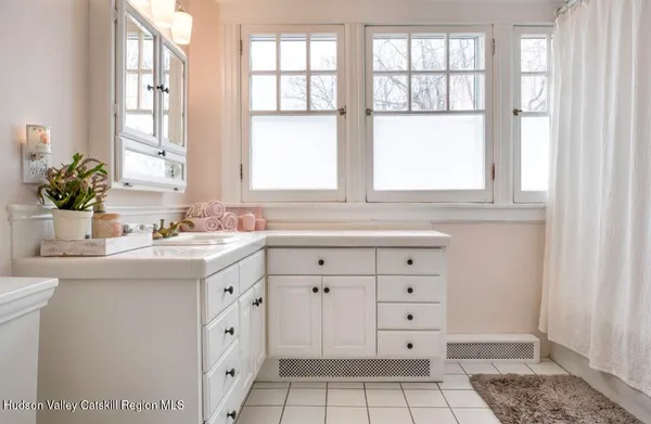 a bathroom with a sink double vanity and a window