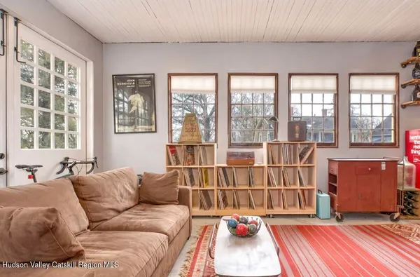 a living room with furniture and a floor to ceiling window