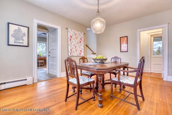 a view of a dining room with furniture wooden floor and chandelier