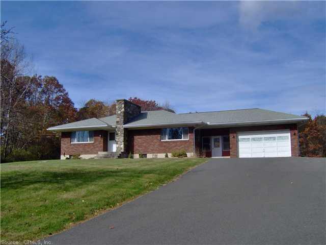 a front view of a house with a garden and yard