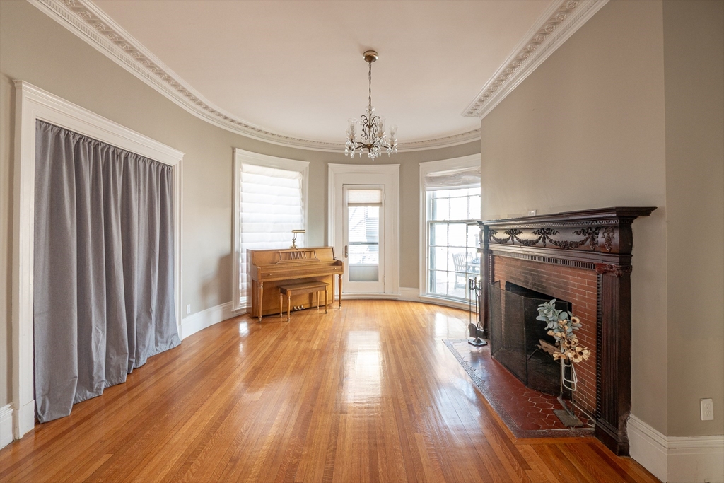 11 Wayne Street Boston, MA 02121 - Photo 4 of 27 a view of a livingroom with furniture wooden floor fireplace and windows