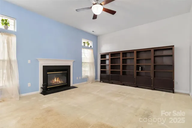 a view of a livingroom with wooden floor and a chandelier