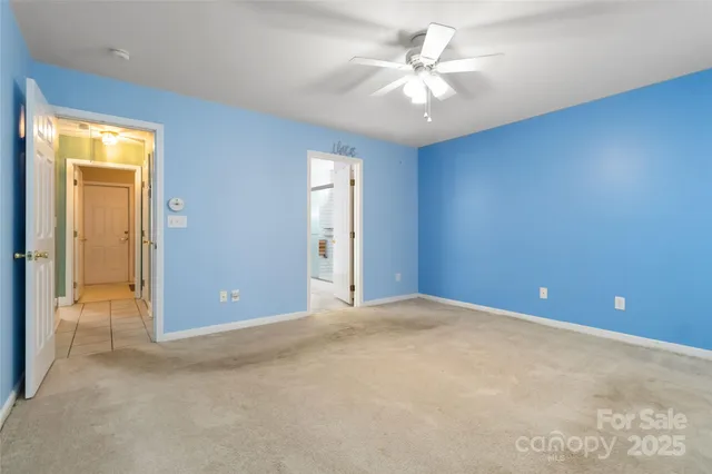 a bathroom with a granite countertop sink a toilet and a mirror