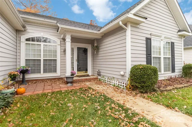 a view of a backyard with a chair and tables