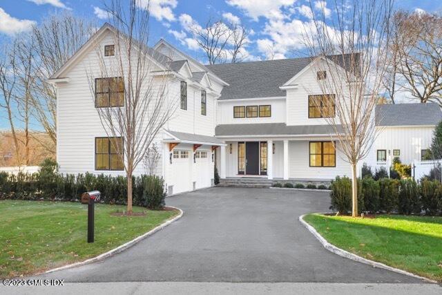 204 Sheep Hill Road Riverside, CT 06878 - Photo 1 of 62 a front view of a house with a yard and garage