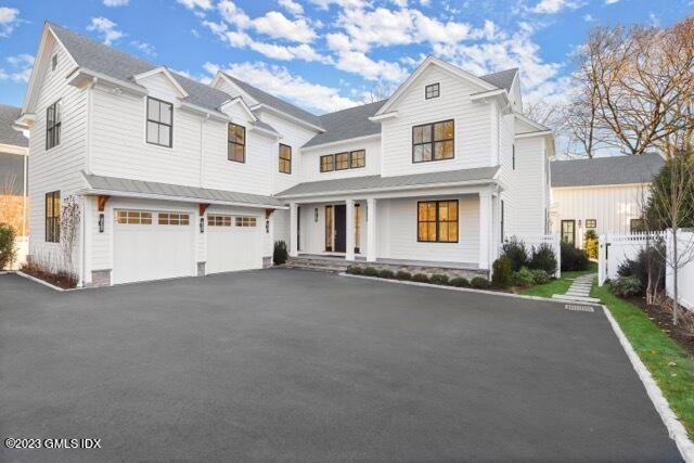 204 Sheep Hill Road Riverside, CT 06878 - Photo 50 of 62 a view of a white house with a large windows