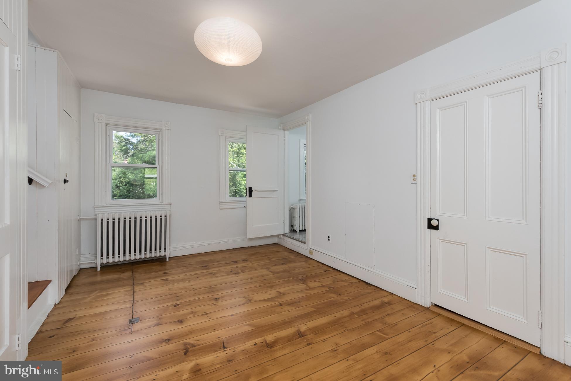 146 Carter Road Princeton, NJ 08540 - Photo 23 of 39 an empty room with wooden floor and windows