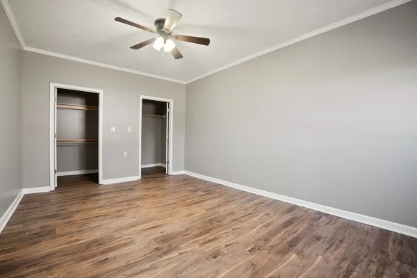 a view of empty room with wooden floor