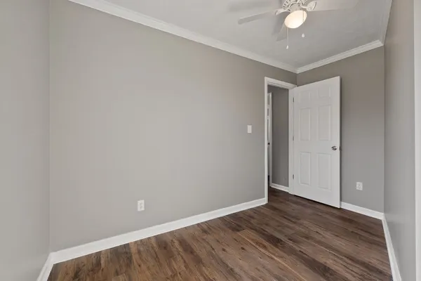 a view of an empty room with wooden floor