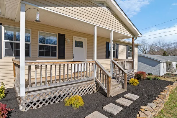 a view of a house with wooden fence