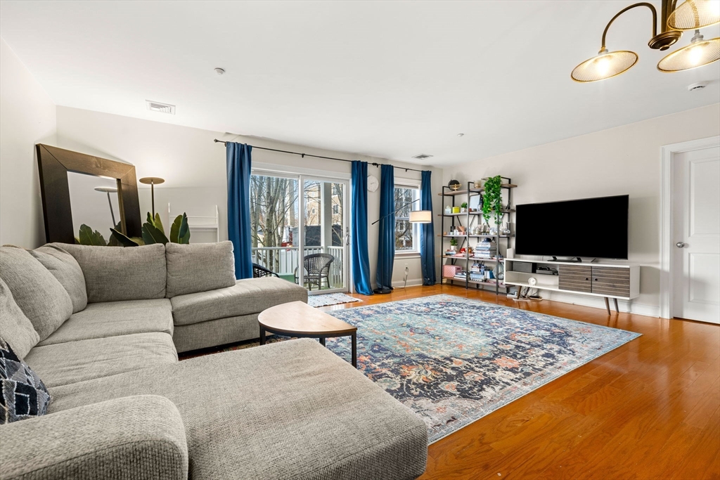 11 Cheriton Road, Unit 102 Boston, MA 02132 - Photo 13 of 42 a living room with furniture and a flat screen tv