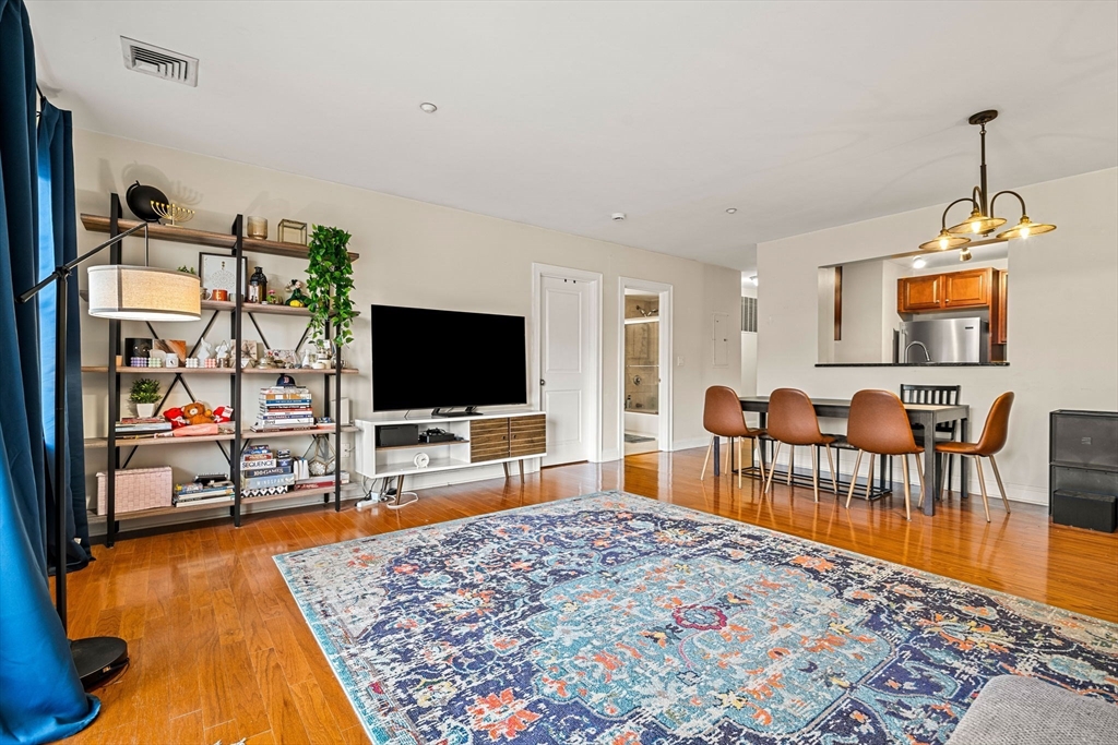 11 Cheriton Road, Unit 102 Boston, MA 02132 - Photo 15 of 42 a living room with furniture and a flat screen tv