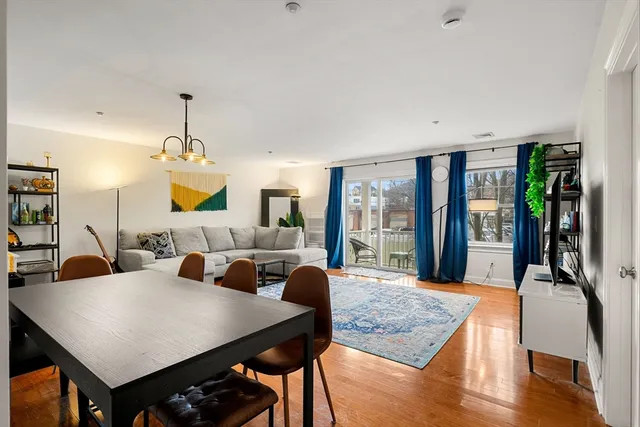 a living room with furniture a chandelier and a table