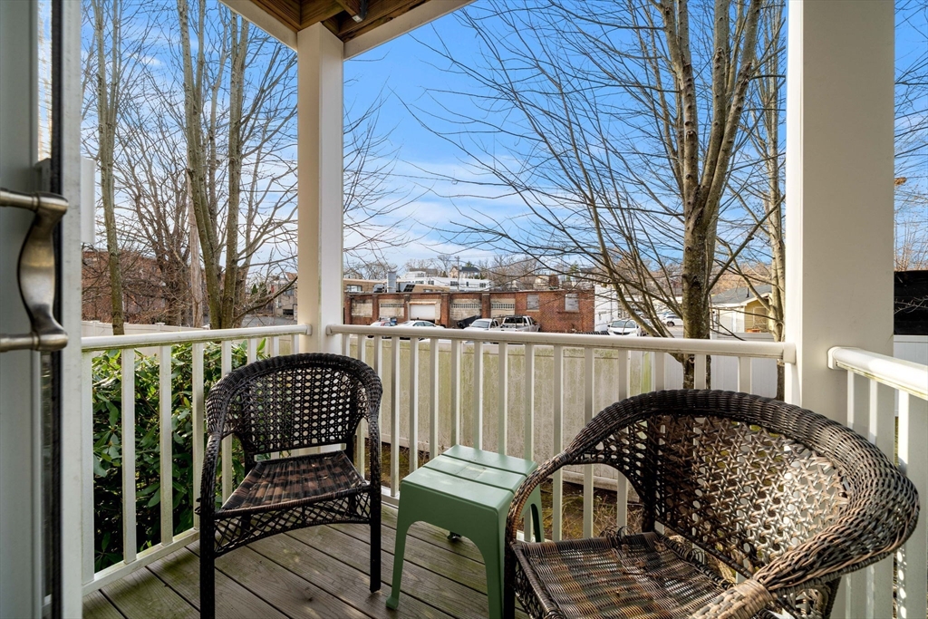 11 Cheriton Road, Unit 102 Boston, MA 02132 - Photo 24 of 42 a view of a chair and table in the balcony