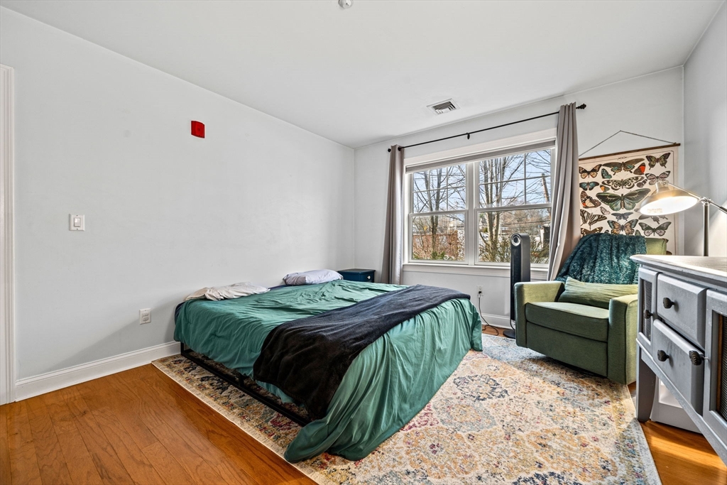 11 Cheriton Road, Unit 102 Boston, MA 02132 - Photo 26 of 42 a bed room with a bed and a couch