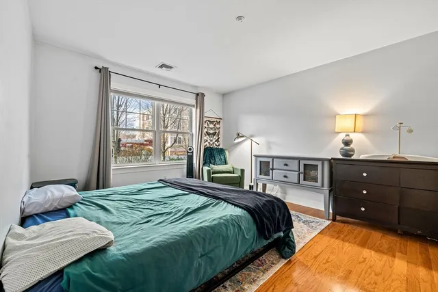 a bedroom with a bed and window