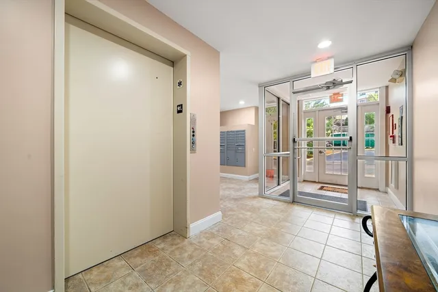 a bathroom with a glass shower door and a mirror
