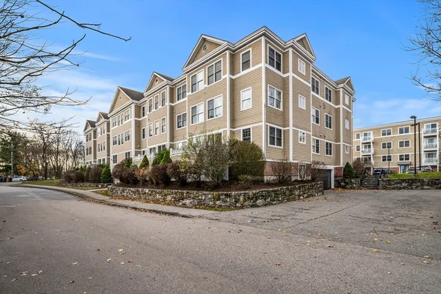 a front view of a building with lot of street